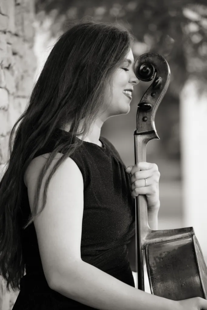 Cecilia Huerta-Lauf in profile with the scroll of her cello